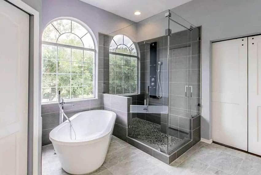 Bathroom with French windows, enclosed shower with half wall design and tub