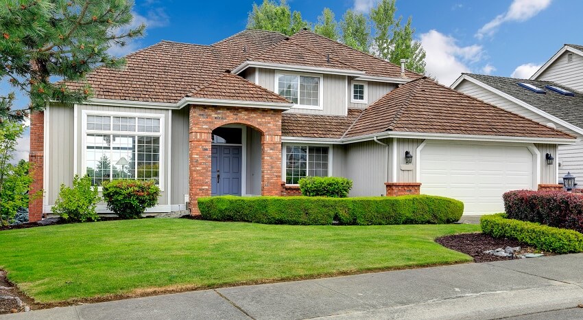 Classic house exterior with brick trimmed entrance portico,