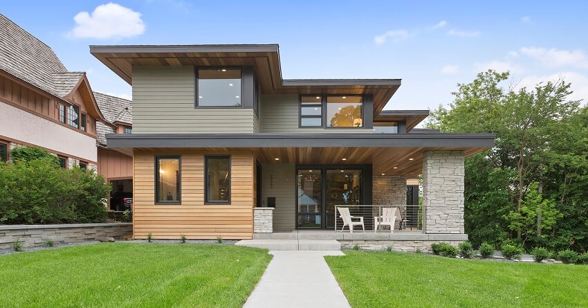 Concrete walkway leading to the closed porch of a modern home