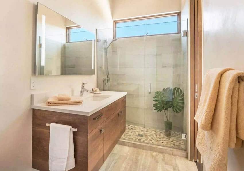 Bathroom with frameless shower, shower area and floating vanity shelf
